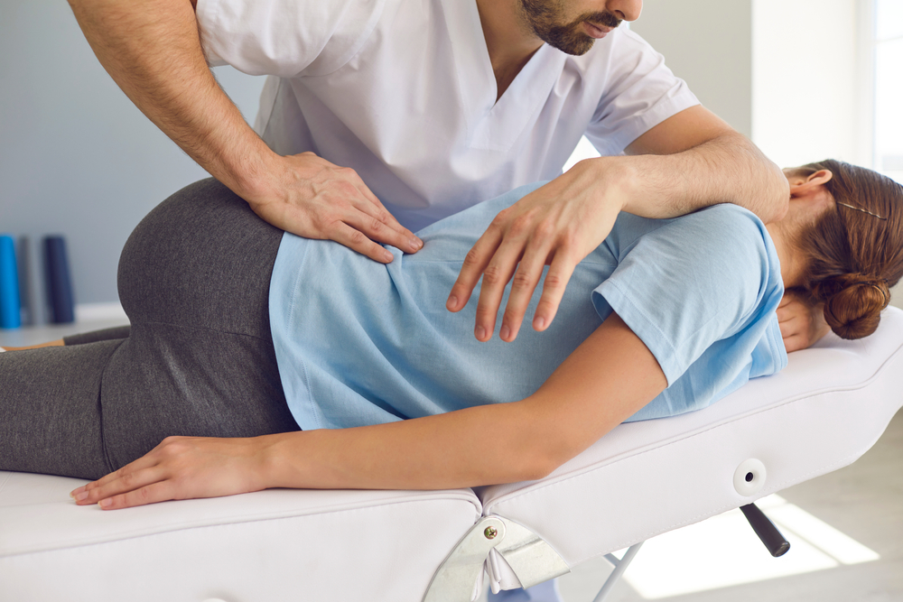 Chiropractor treating a patient adjustments
